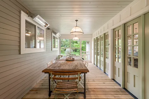 a dining room with wooden floor and a table