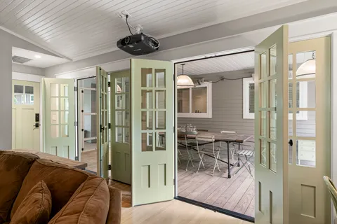 a living room with furniture and a chandelier