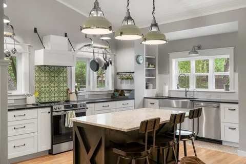 a large kitchen with a table and chairs