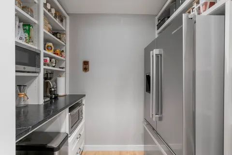 a view of walk in closet with empty racks