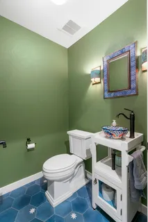 a bathroom with a sink a toilet and mirror