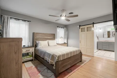 a bedroom with a large bed and a chandelier
