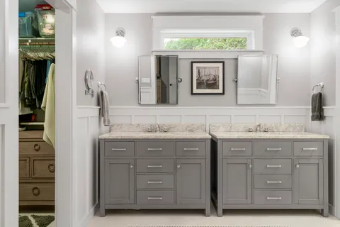 a bathroom with a granite countertop sink vanity and mirror