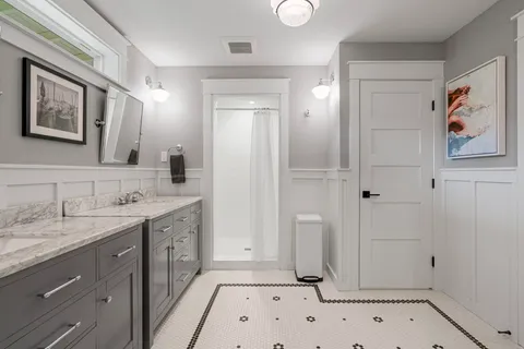 a spacious bathroom with a granite countertop sink a mirror a shower and a bathtub