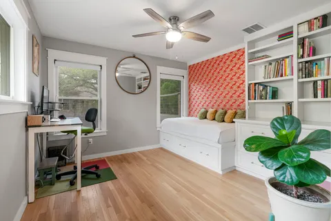 a living room with furniture a window and a bookshelf