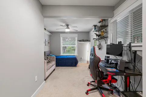 a view of a workspace with furniture and a window