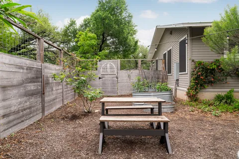 a view of a wooden bench sitting in backyard