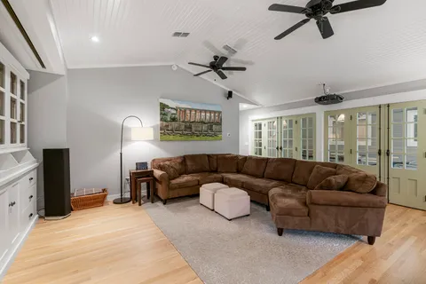 a living room with furniture ceiling fan and a rug