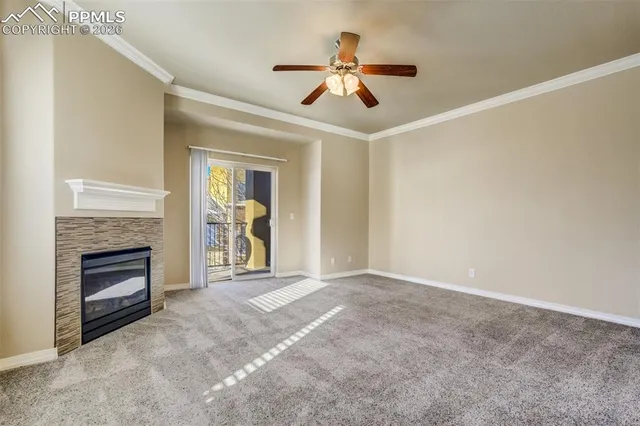 a view of an empty room with a fireplace and a window