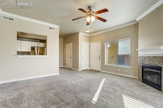 an empty room with a fireplace and fan