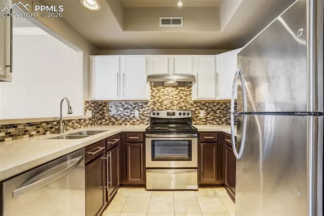 a view of a room with a ceiling fan and a window