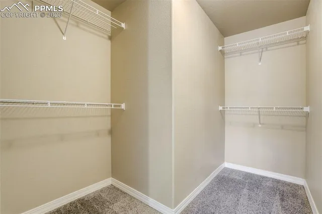 an empty room with closet and wooden floor