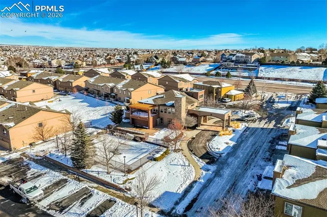 an aerial view of residential houses with outdoor space