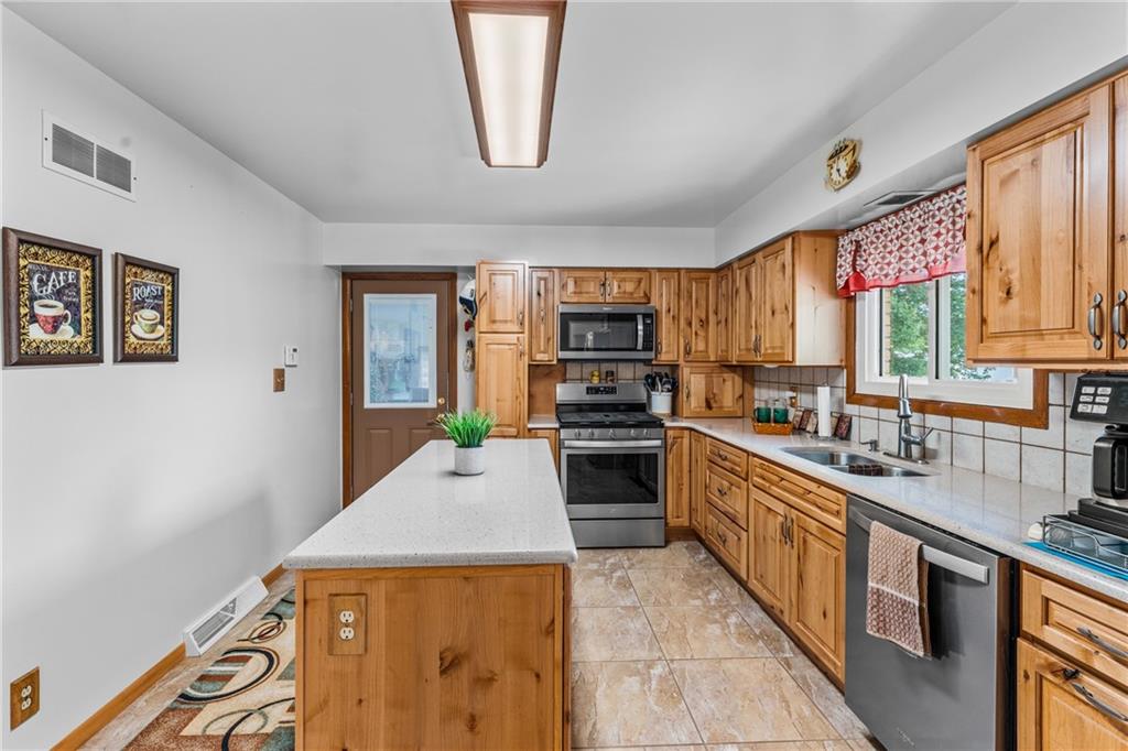 3933 Mitchell Road New Castle, PA 16105 - Photo 3 of 6 a kitchen with stainless steel appliances granite countertop a stove a sink a refrigerator and a microwave