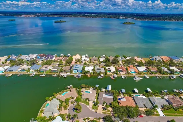 a view of a patio with couches table and chairs with wooden floor and fence