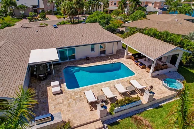 a view of swimming pool with outdoor seating and a patio
