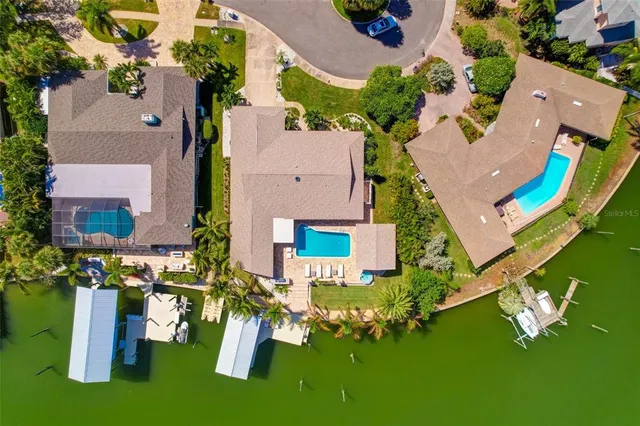 an aerial view of a house with a garden potted plants and large trees