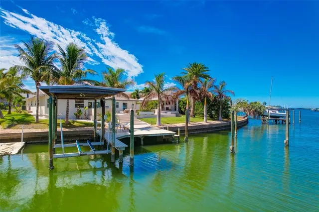 an aerial view of residential houses with outdoor space and river