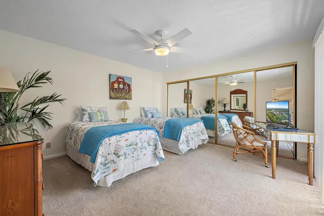 a bedroom with two beds and a chandelier