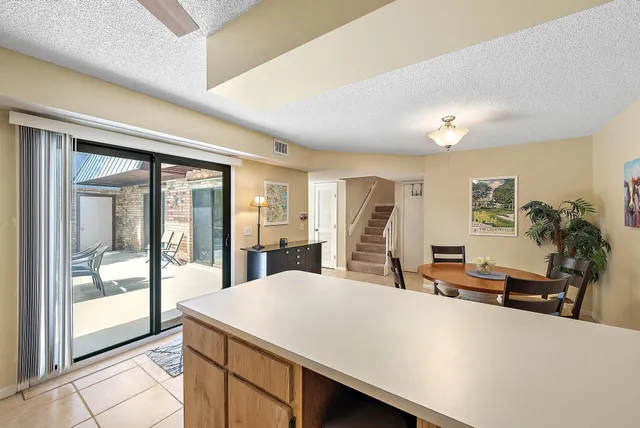 a room with pool table and glass windows