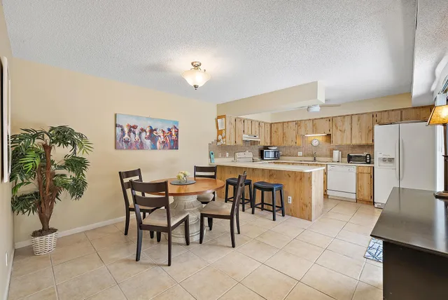 a view of kitchen with sink dining table and chairs