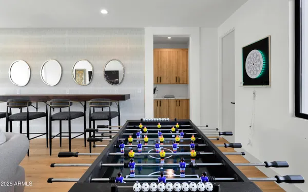 a room with lots of white furniture and paintings on the wall