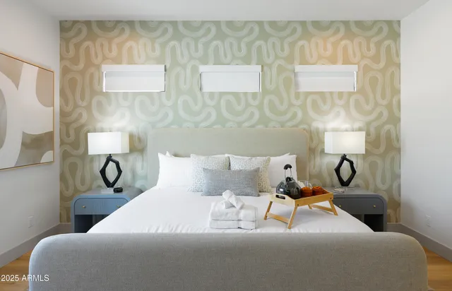 a bed room with a bed and wall painting