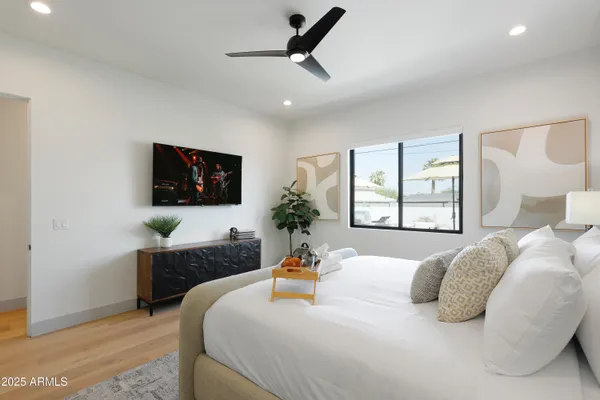 a bedroom with a bed and a flat screen tv