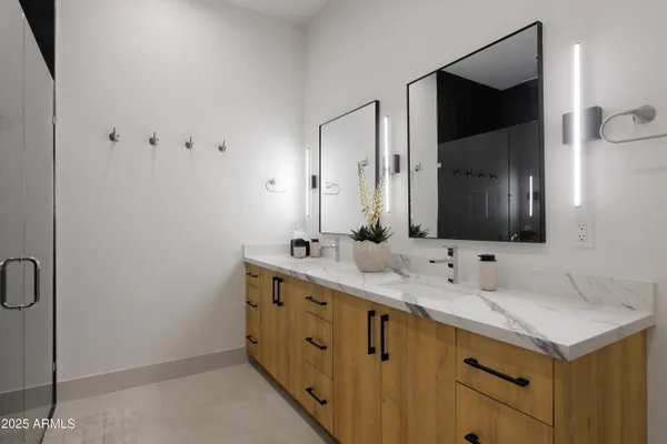 a bathroom with a double vanity sink and mirror