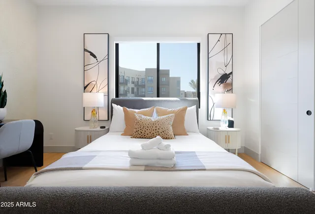 a bedroom with a large bed and a large window