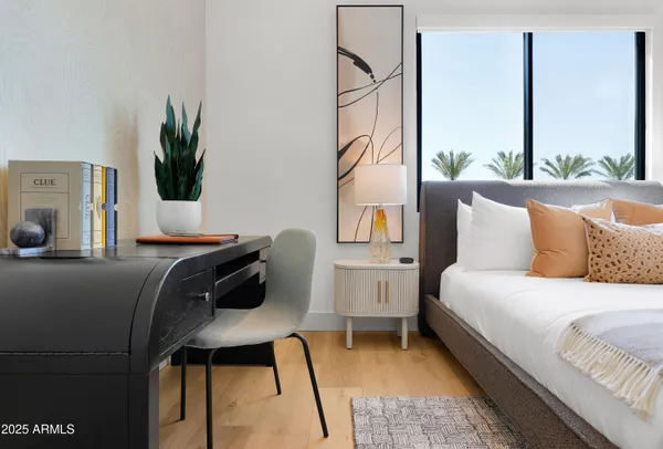 a bedroom with a bed and a potted plant