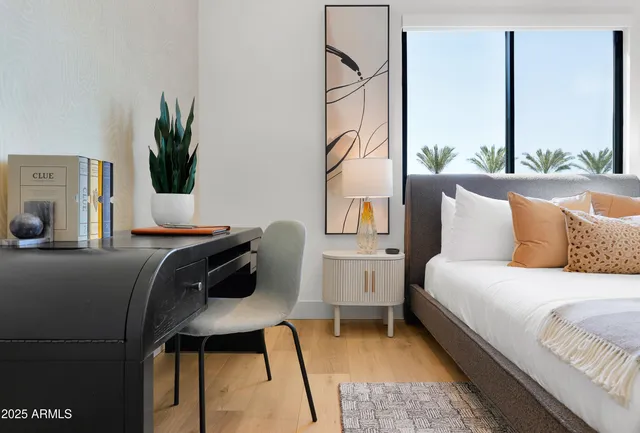 a bedroom with a bed and a potted plant