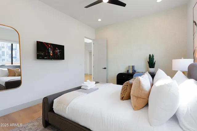 a bedroom with two beds and a flat screen tv