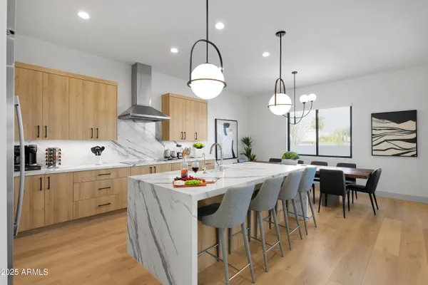 a large kitchen with a table and chairs