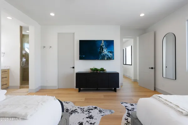 a bedroom with a bed and a flat screen television