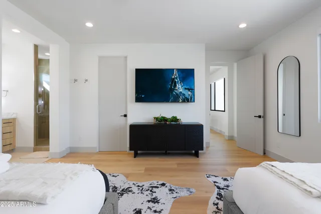 a bedroom with a bed and a flat screen television
