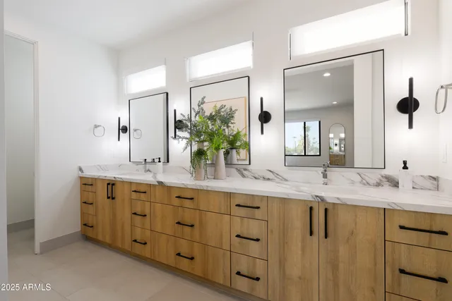 a bathroom with a granite countertop sink mirror and double