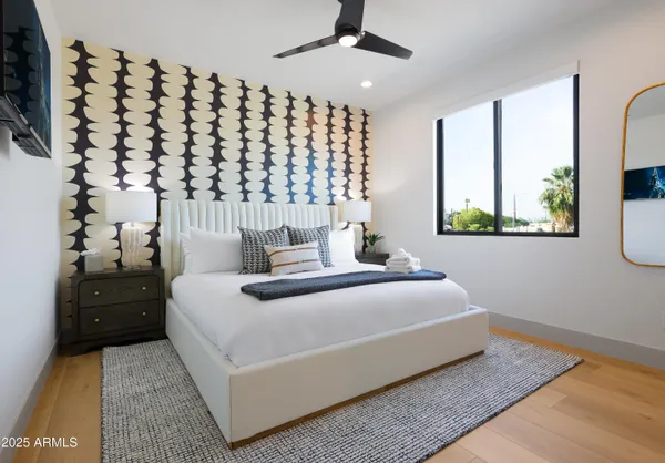 a bedroom with a bed and a night stand