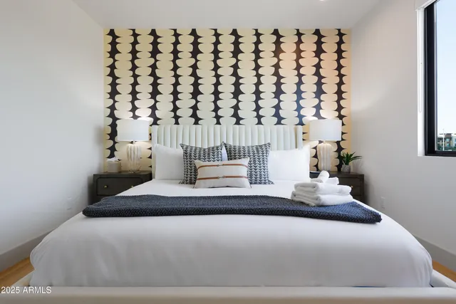 a bedroom with a bed and a potted plant