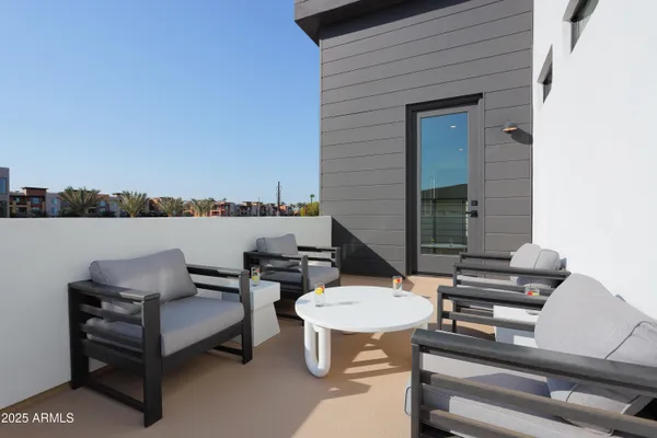 a outdoor living space with chairs and a table