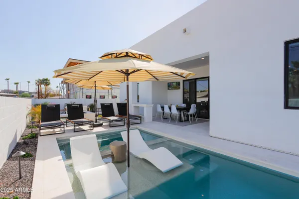 a patio with a table and chairs