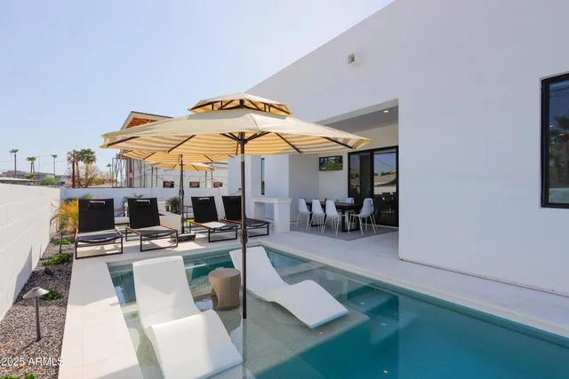 a patio with a table and chairs