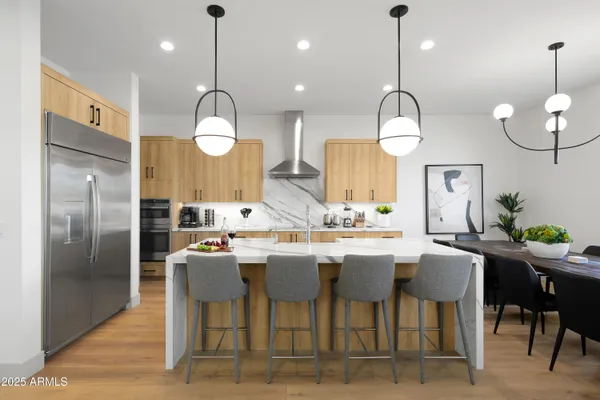 a kitchen with a dining table chairs sink and cabinets