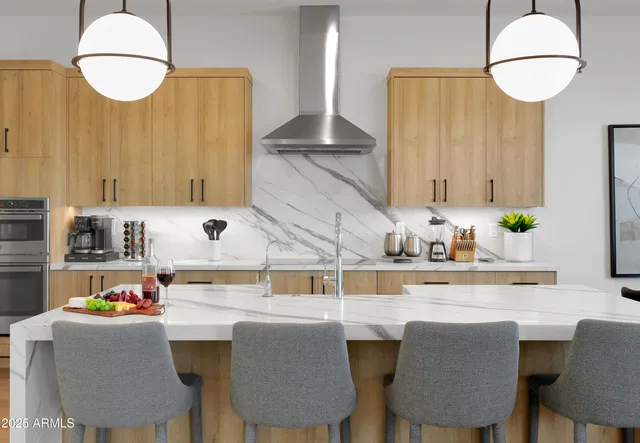 a room with stainless steel appliances a table chairs and a refrigerator