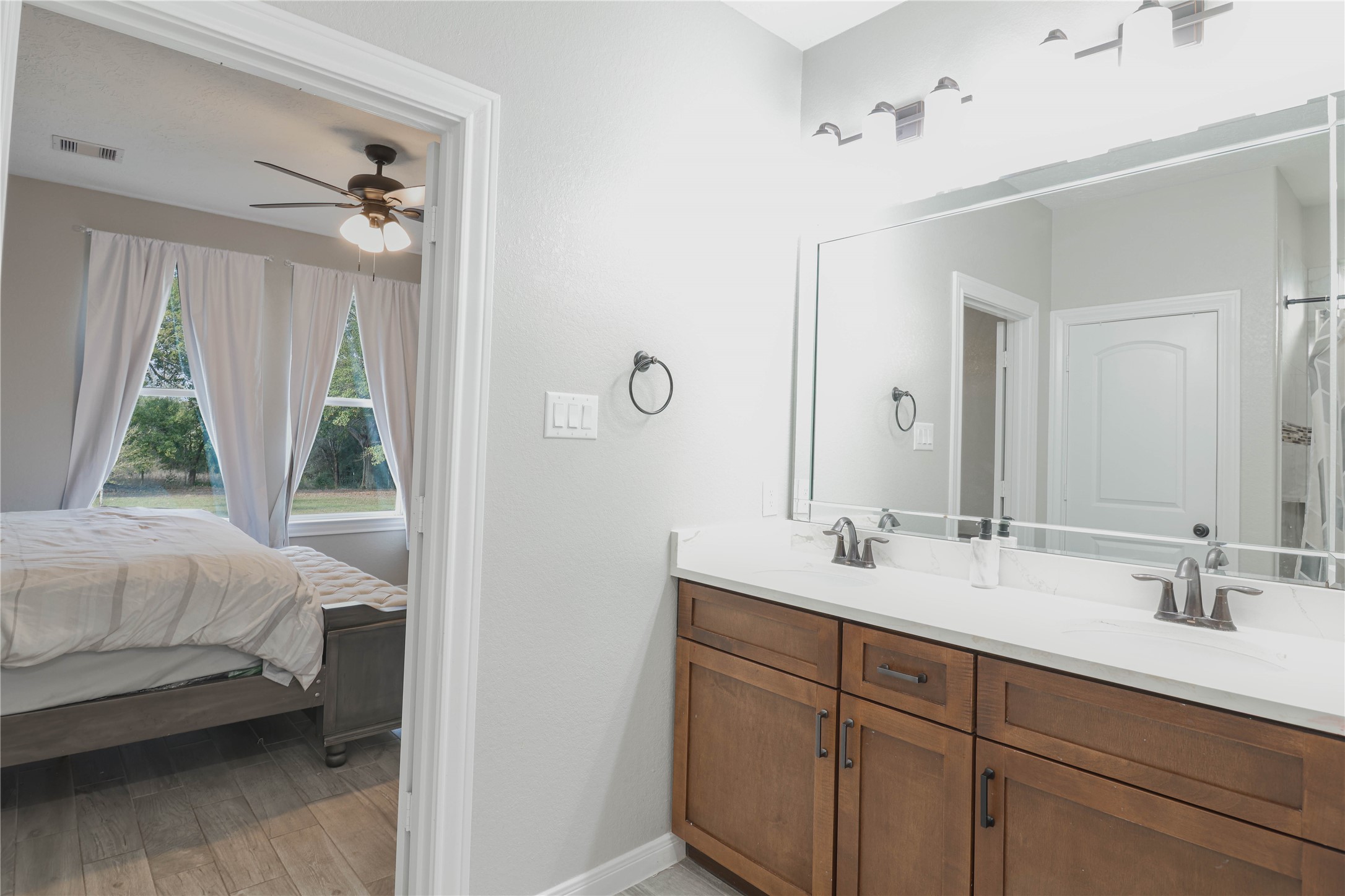 38938 Mt Zion Road Pattison, TX 77423 - Photo 10 of 15 a en suite bathroom with a double vanity sink and a mirror
