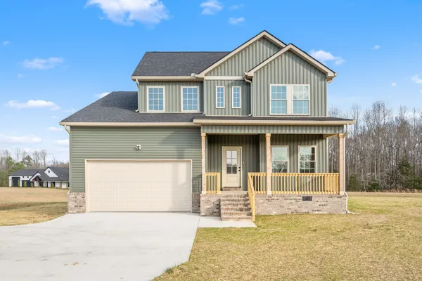 a front view of a house with a yard and garage