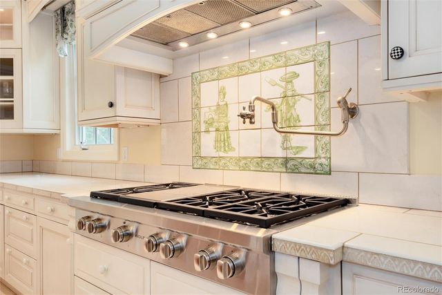 a dining room with wooden floor and chandelier
