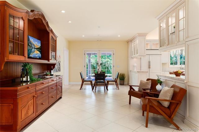 a bedroom with a bed chandelier and window