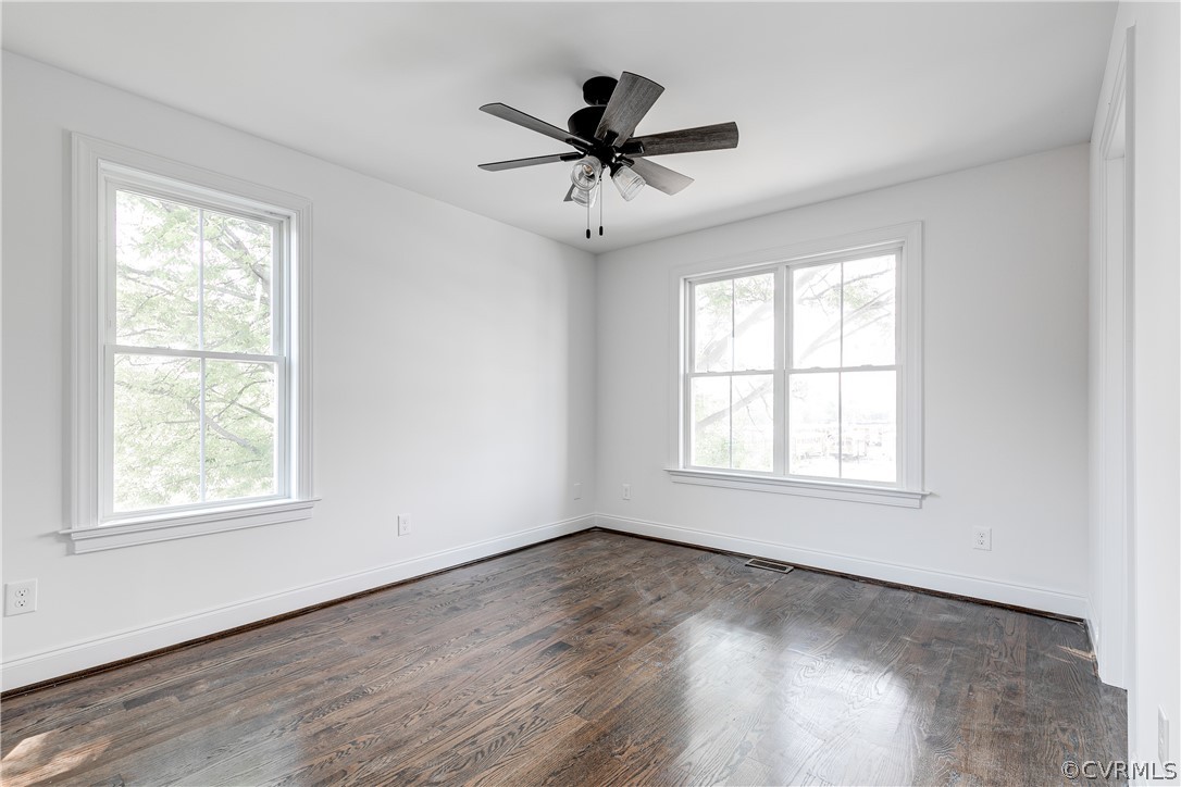 2403 Everett Street Richmond, VA 23224 - Photo 14 of 25 an empty room with wooden floor fan and windows