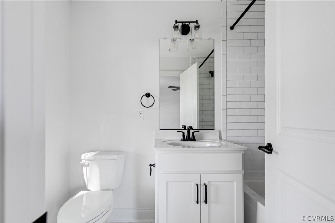 2403 Everett Street Richmond, VA 23224 - Photo 16 of 25 a bathroom with a sink a toilet and mirror